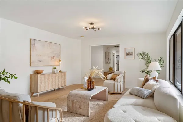 a view of living room kitchen with furniture and wooden floor