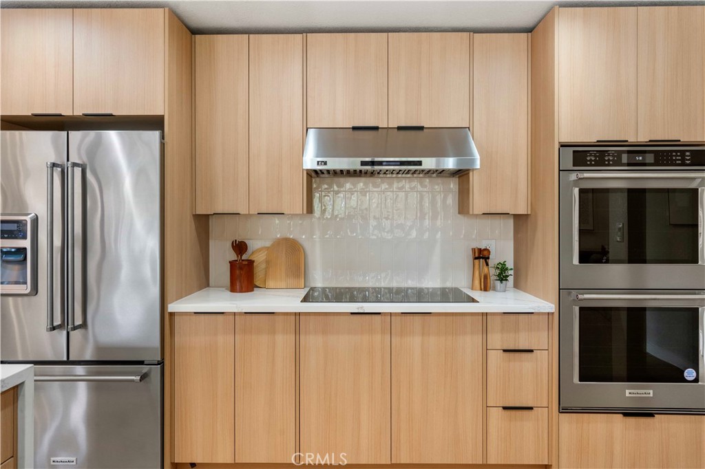 931 Camino Ramon Danville, CA 94526 - Photo 9 of 67 a kitchen with stainless steel appliances granite countertop a refrigerator a stove and a sink with wooden floor