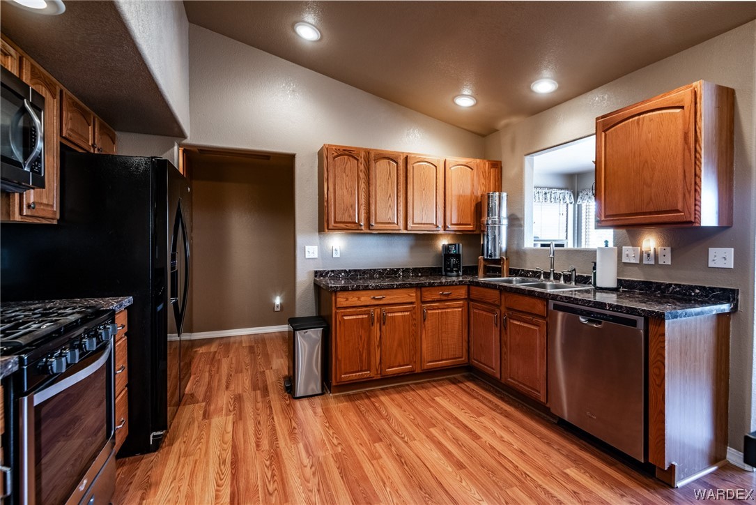 10363 East Blake Ranch Road Kingman, AZ 86401 - Photo 11 of 79 a kitchen with stainless steel appliances granite countertop a stove a sink dishwasher and a refrigerator