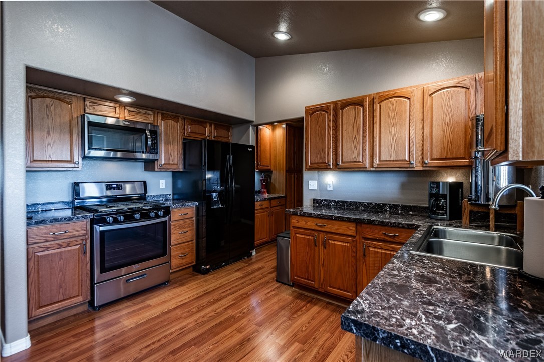 10363 East Blake Ranch Road Kingman, AZ 86401 - Photo 12 of 79 a kitchen with stainless steel appliances granite countertop a stove a sink and a refrigerator