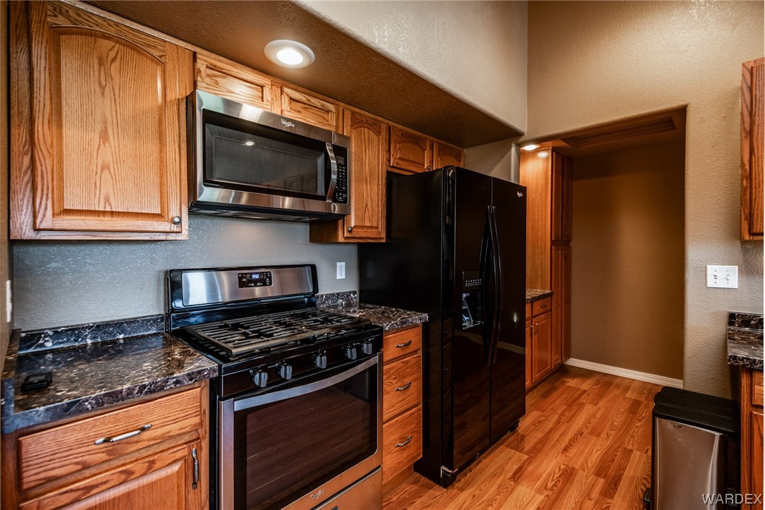 10363 East Blake Ranch Road Kingman, AZ 86401 - Photo 13 of 79 a kitchen with stainless steel appliances granite countertop a stove and a refrigerator