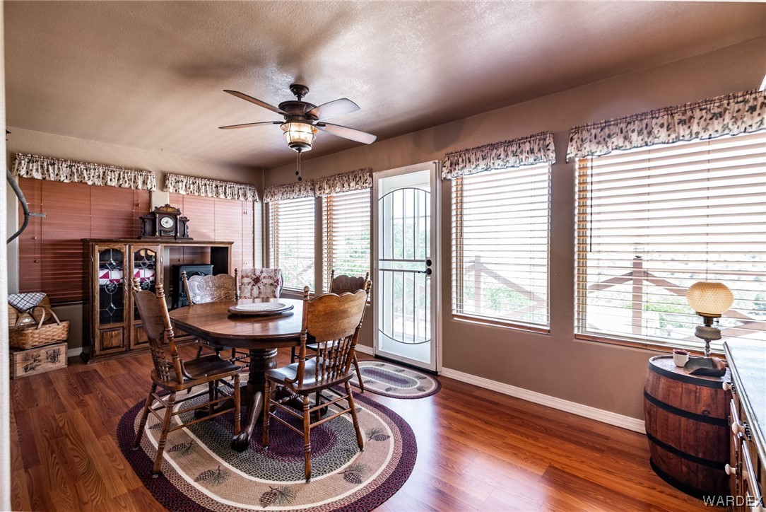 10363 East Blake Ranch Road Kingman, AZ 86401 - Photo 14 of 79 a view of a dining room with furniture window and wooden floor