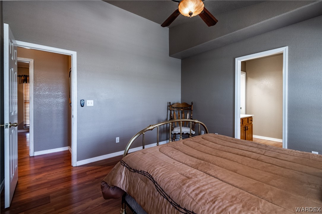 10363 East Blake Ranch Road Kingman, AZ 86401 - Photo 18 of 79 a bedroom with a bed and a chandelier