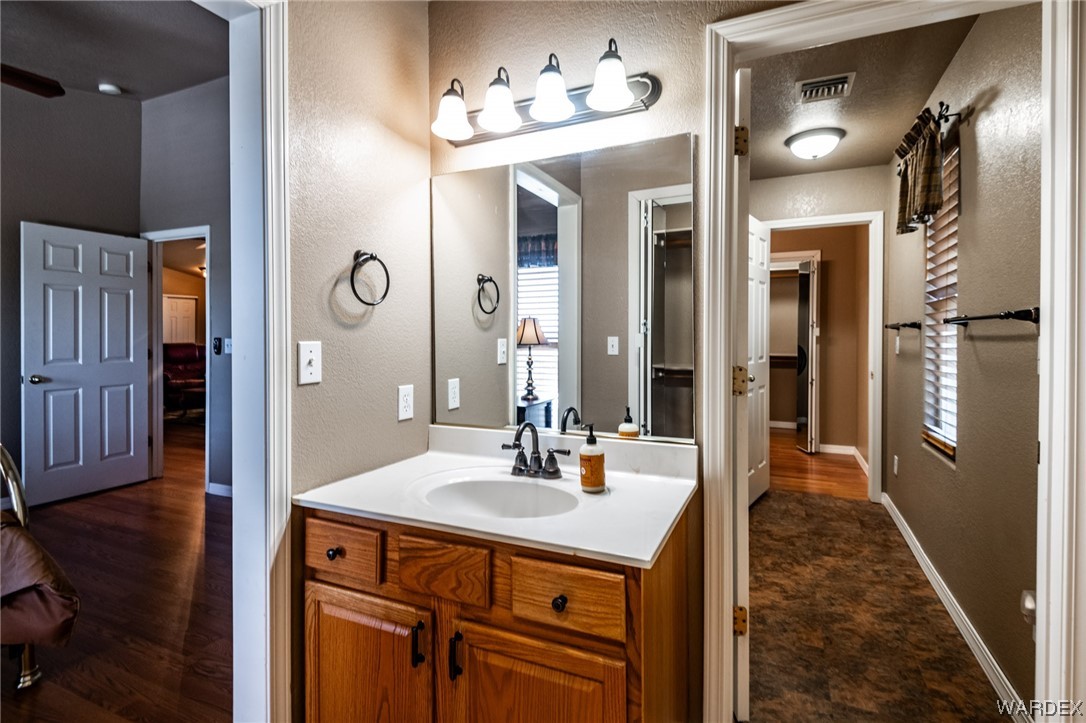10363 East Blake Ranch Road Kingman, AZ 86401 - Photo 25 of 79 a bathroom with a sink vanity and a mirror