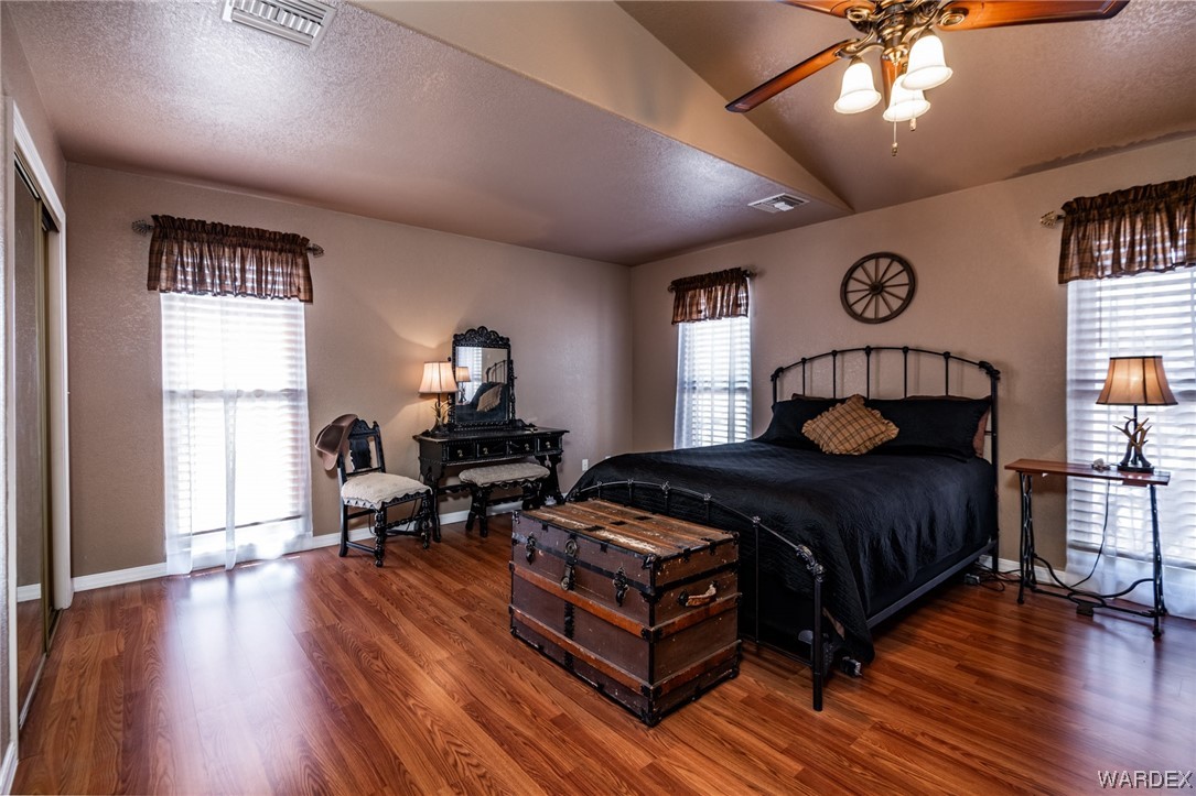 10363 East Blake Ranch Road Kingman, AZ 86401 - Photo 26 of 79 a bedroom with a bed and wooden floor