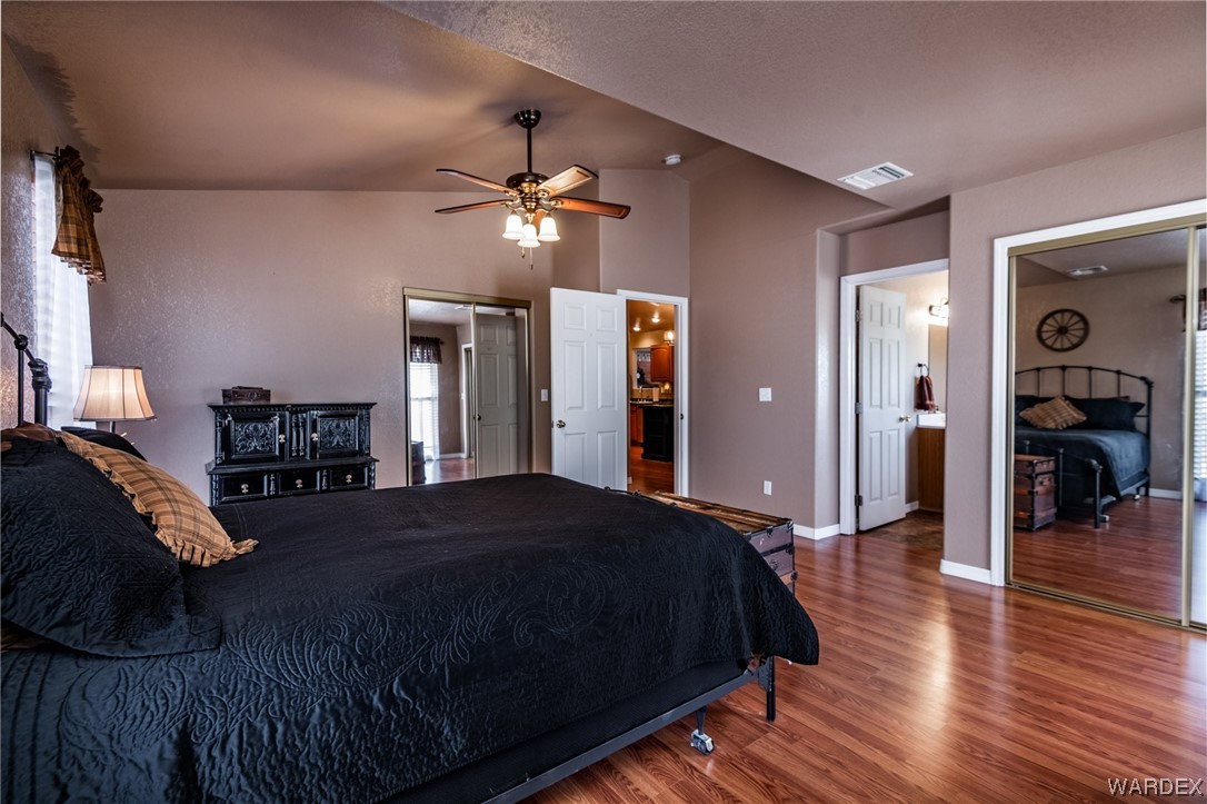 10363 East Blake Ranch Road Kingman, AZ 86401 - Photo 27 of 79 a bedroom with a bed and wooden floor
