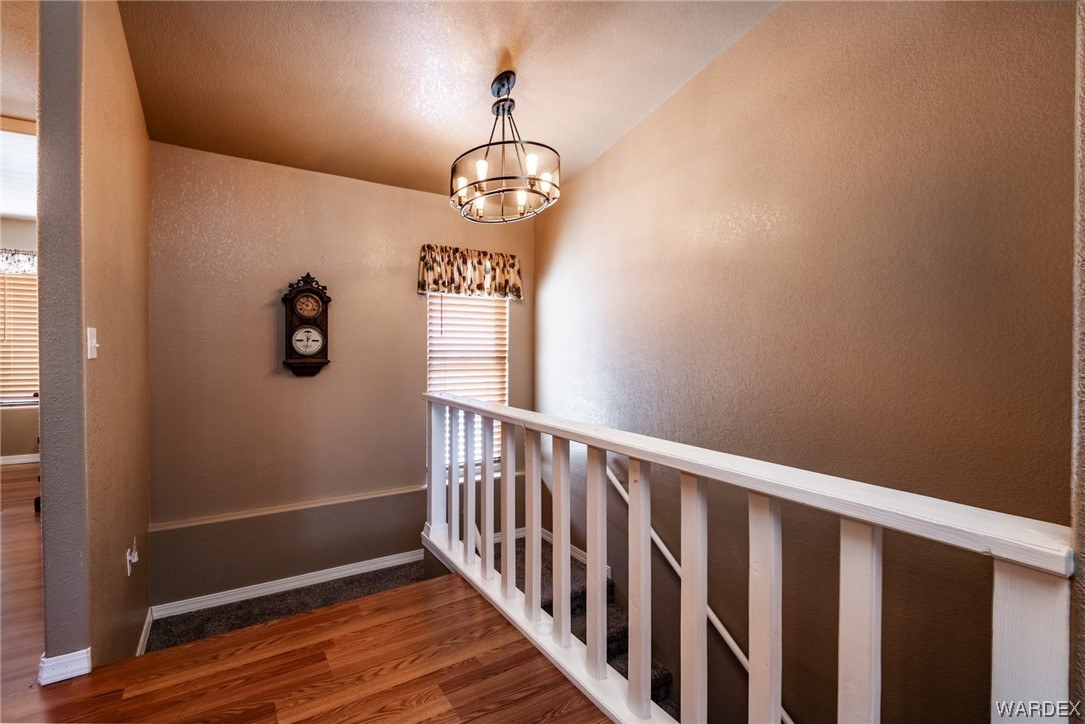 10363 East Blake Ranch Road Kingman, AZ 86401 - Photo 30 of 79 a view of a hallway with wooden floor
