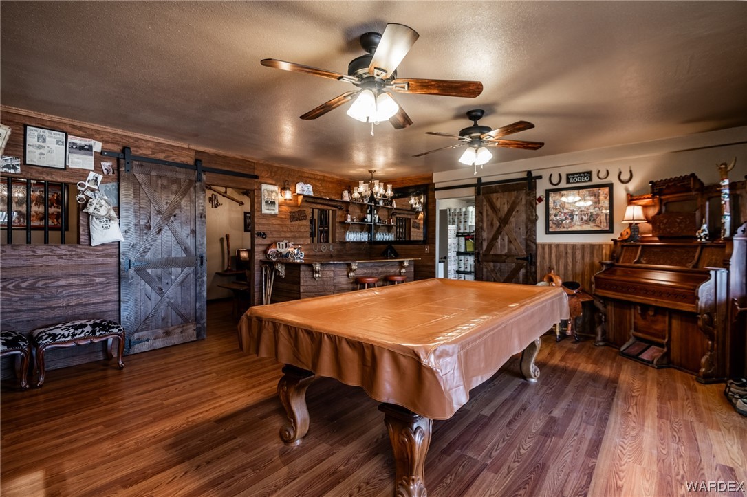 10363 East Blake Ranch Road Kingman, AZ 86401 - Photo 34 of 79 a very nice looking room with furniture and wooden floor