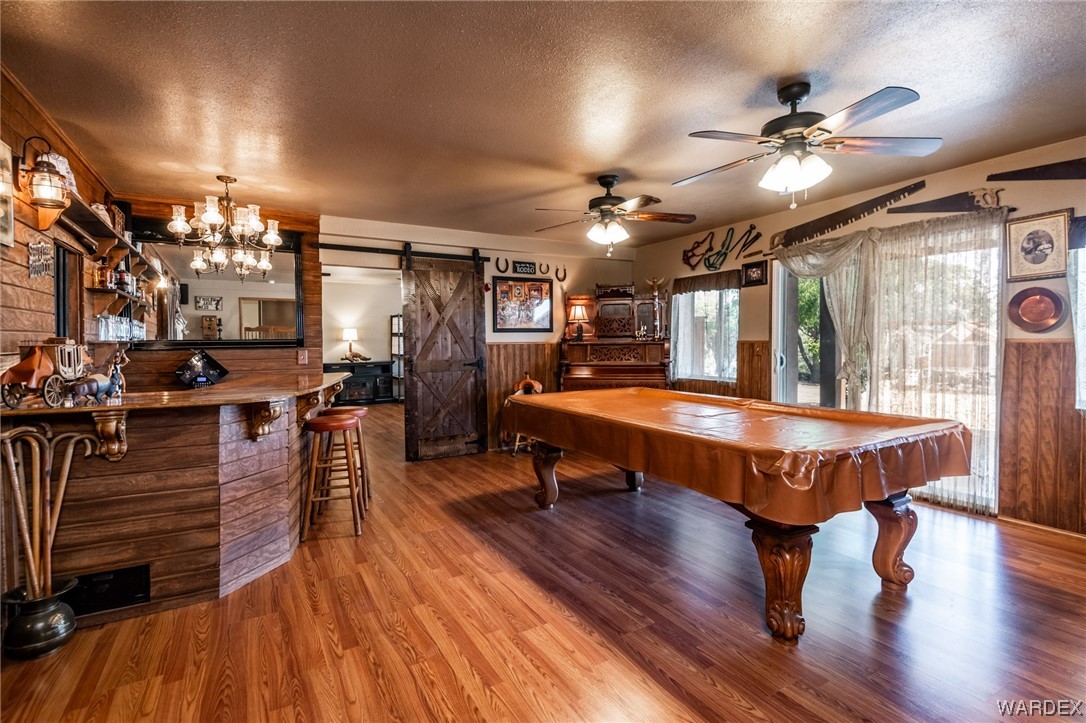 10363 East Blake Ranch Road Kingman, AZ 86401 - Photo 35 of 79 a room with lots of wooden furniture lots of wooden furniture and a chandelier