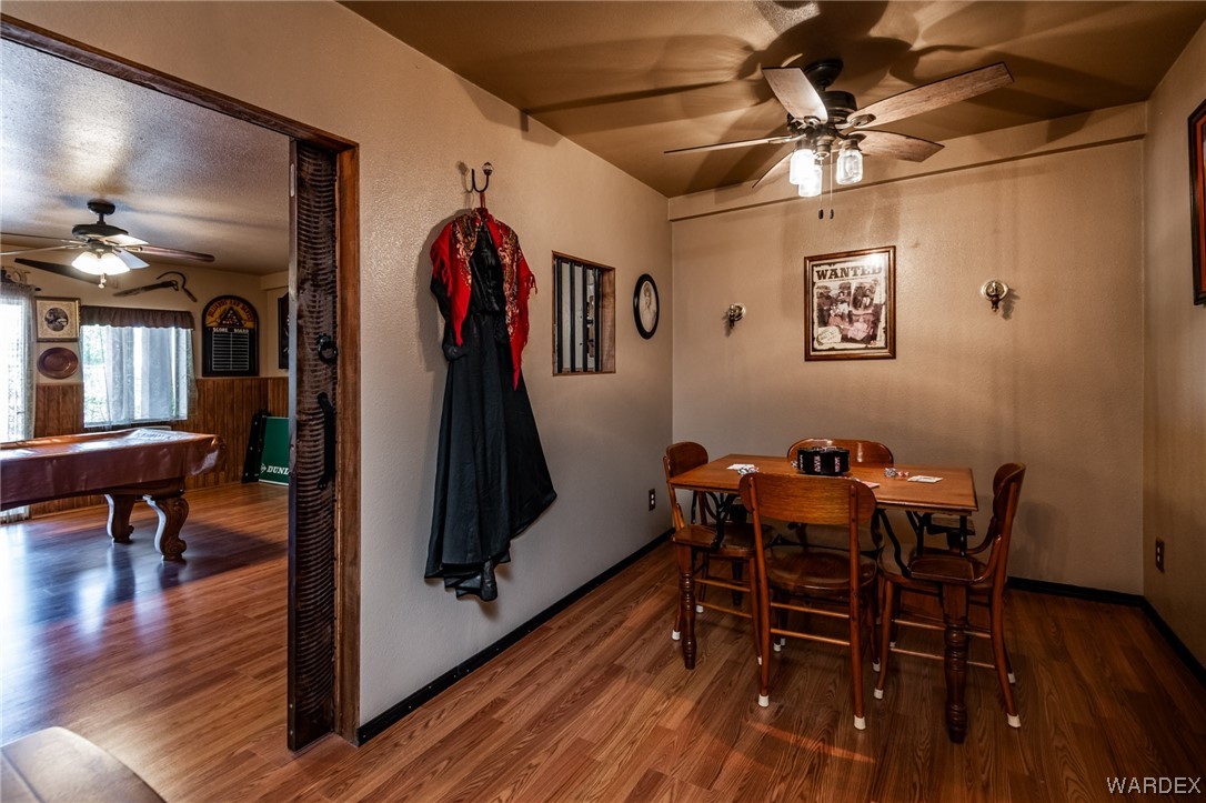 10363 East Blake Ranch Road Kingman, AZ 86401 - Photo 36 of 79 a dining room with furniture and wooden floor