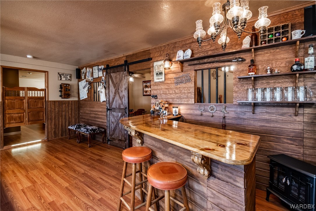 10363 East Blake Ranch Road Kingman, AZ 86401 - Photo 38 of 79 a room with table chairs and a chandelier