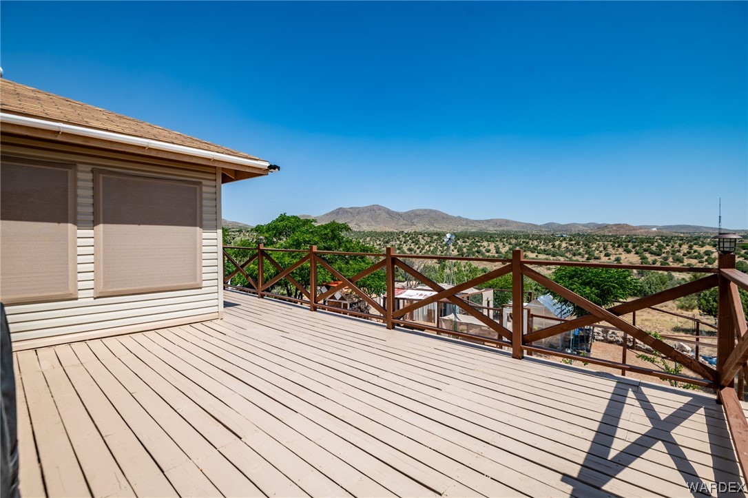 10363 East Blake Ranch Road Kingman, AZ 86401 - Photo 49 of 79 a view of a roof deck with wooden floor and fence
