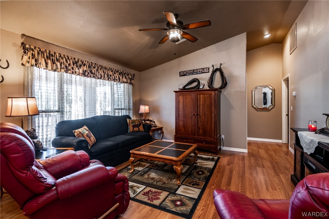 10363 East Blake Ranch Road Kingman, AZ 86401 - Photo 9 of 79 a living room with furniture a ceiling fan and a window