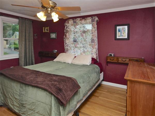 42 Felch Road Natick, MA 01760 - Photo 12 of 21 a bedroom with a bed and a dresser with wooden floor