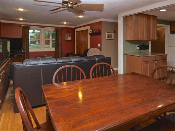 42 Felch Road Natick, MA 01760 - Photo 3 of 21 a kitchen with stainless steel appliances granite countertop a sink a stove and a microwave