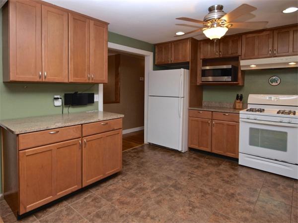 42 Felch Road Natick, MA 01760 - Photo 4 of 21 a kitchen with cabinets stainless steel appliances and a chandelier