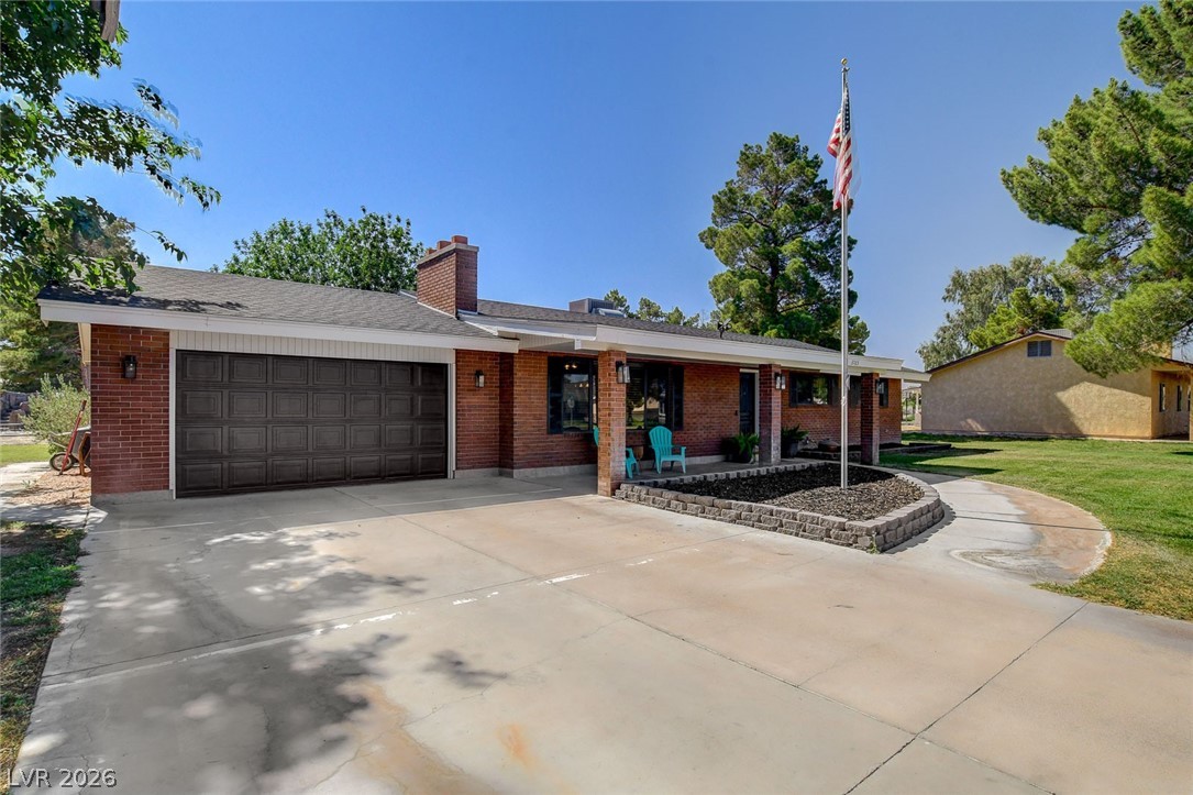 3765 Berkeley Street Logandale, NV 89021 - Photo 14 of 87 This classic brick ranch home features a two-car garage and a well-maintained front yard.