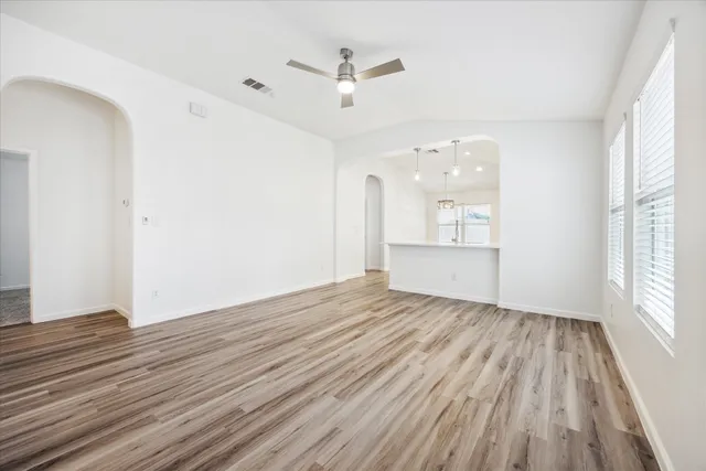 wooden floor in an empty room with a window