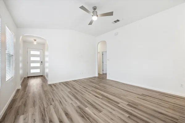 wooden floor in an empty room with a window