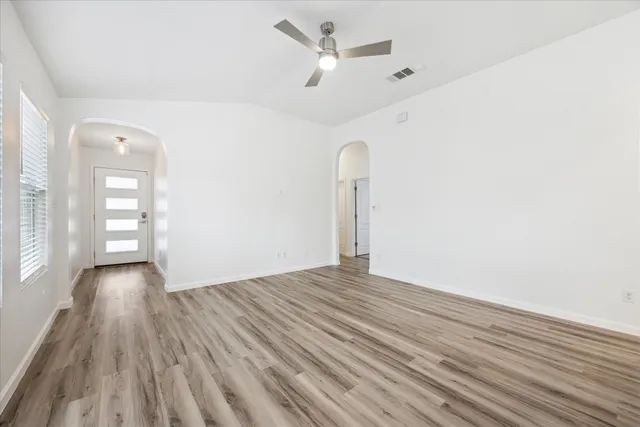 wooden floor in an empty room with a window