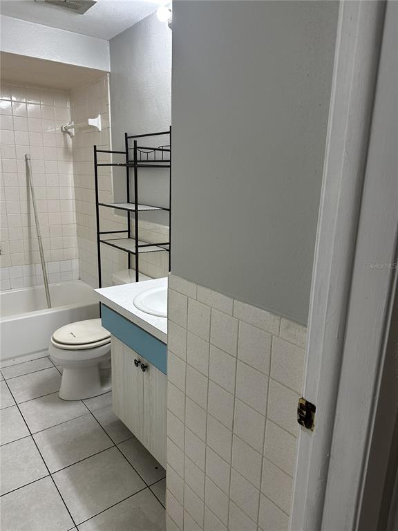 5509 Riddle Road Holiday, FL 34690 - Photo 8 of 13 a bathroom with a toilet a sink and shower