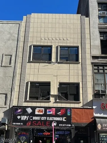 a view of kitchen with stainless steel appliances wooden floor and dining table