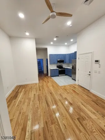 a view of kitchen with refrigerator microwave and cabinets