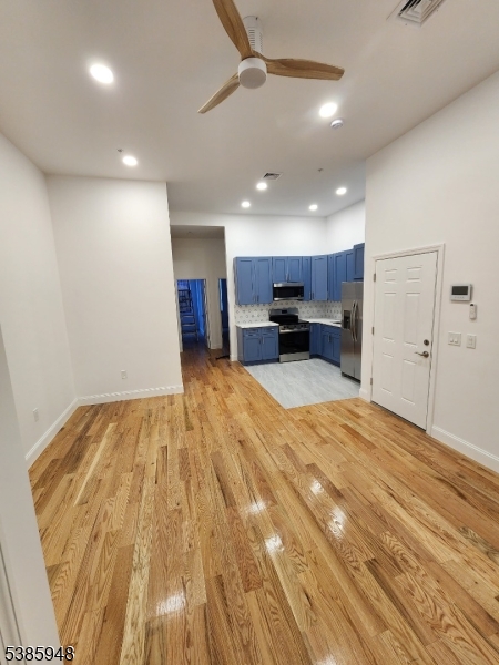189 Main Street, Unit 3B Paterson, NJ 07505 - Photo 2 of 5 a view of kitchen with refrigerator microwave and cabinets