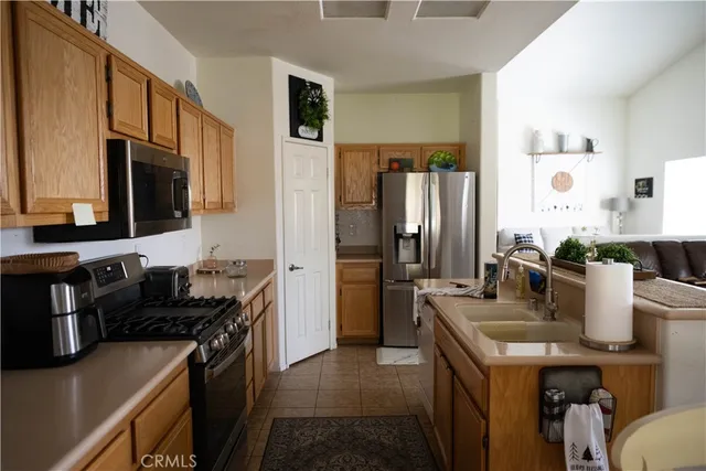 a kitchen with granite countertop a sink stove and refrigerator
