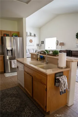 a kitchen with stainless steel appliances granite countertop a stove a refrigerator and a sink