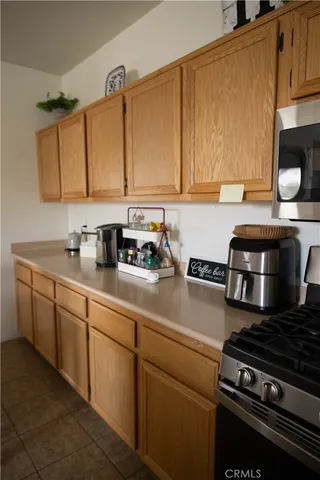 a kitchen with stainless steel appliances a sink dishwasher stove and cabinets