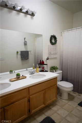 a bathroom with a toilet and a shower curtain