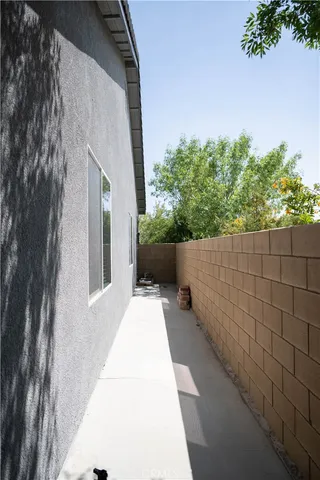 a view of a porch with furniture and garden