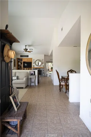 a living room with furniture and a gym machine