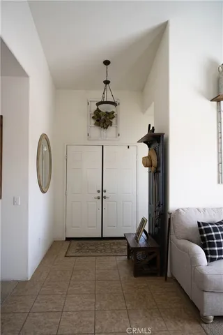 a living room with furniture a window and gym equipment