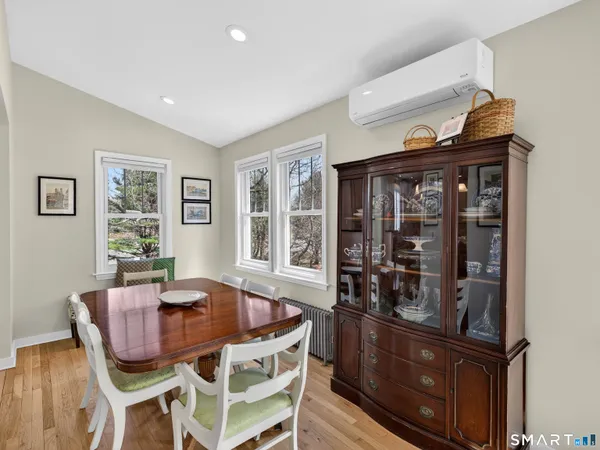 a view of a dining room with furniture and a kitchen