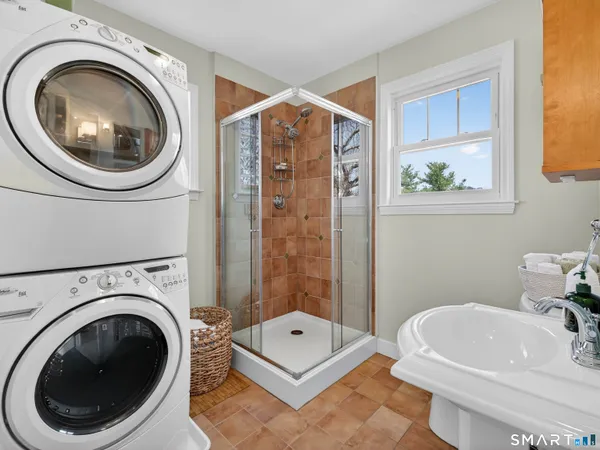 a bathroom with a sink a toilet and mirror