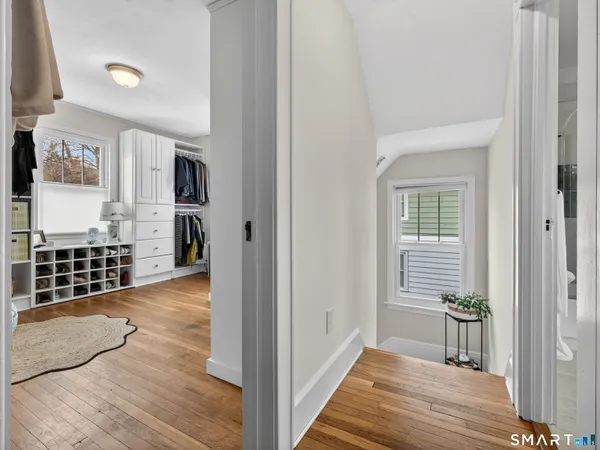 a bedroom with a bed and a lamp on dresser