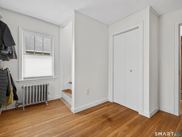 a room with a dresser and a window