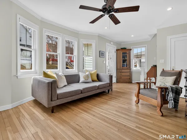a living room with furniture and wooden floor