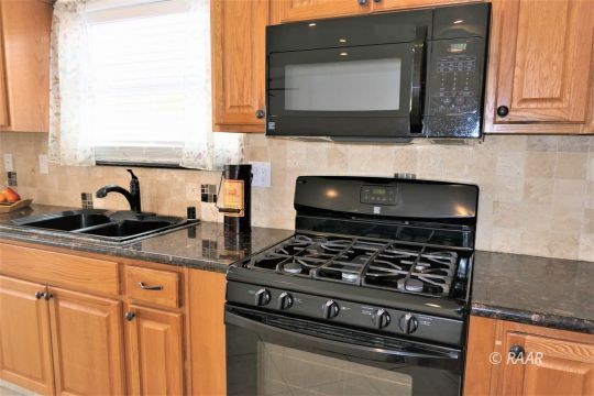 1516 Mayo Street Ridgecrest, CA 93555 - Photo 14 of 33 a kitchen with granite countertop a stove and a sink