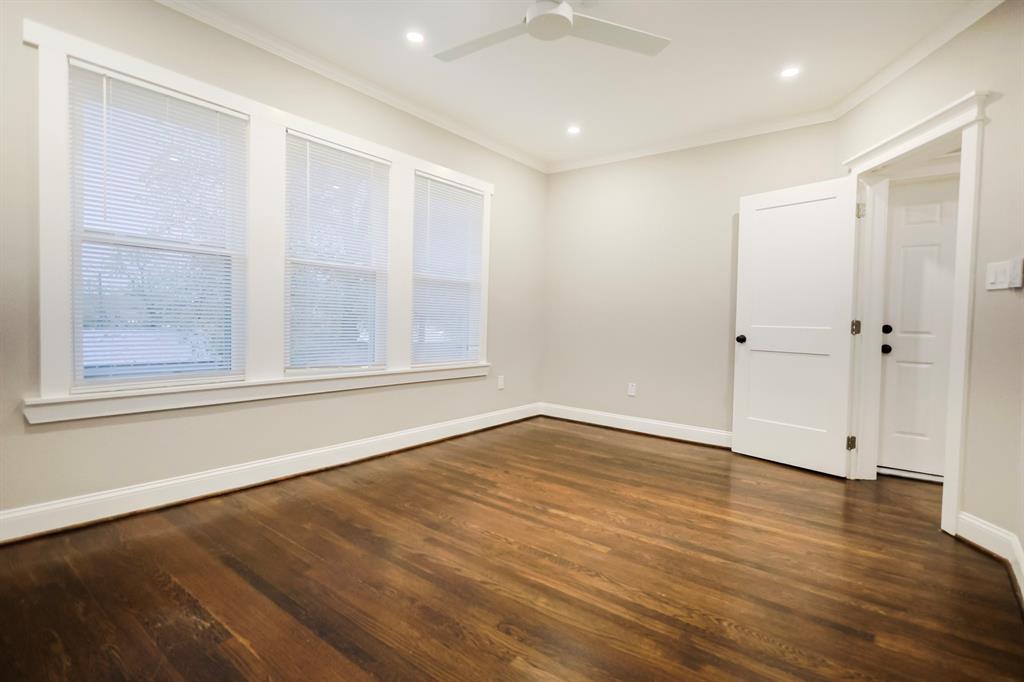 4114 Junius Street, Unit B Dallas, TX 75246 - Photo 12 of 13 an empty room with wooden floor and windows