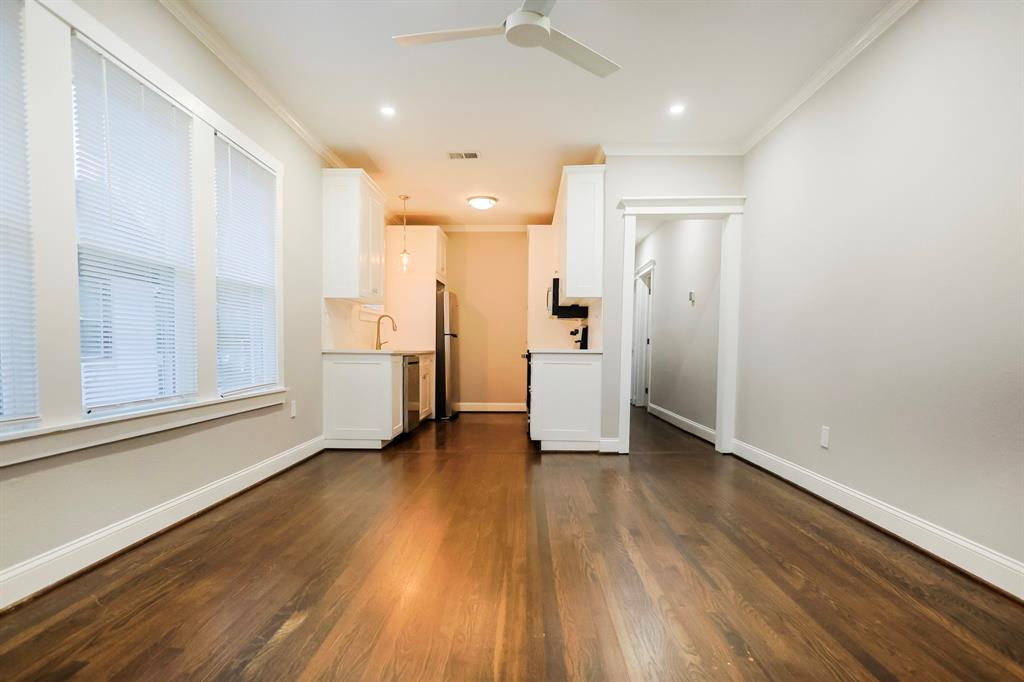 4114 Junius Street, Unit B Dallas, TX 75246 - Photo 5 of 13 a view of a room with wooden floor and windows
