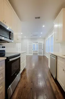 a view of kitchen with sink microwave and cabinets
