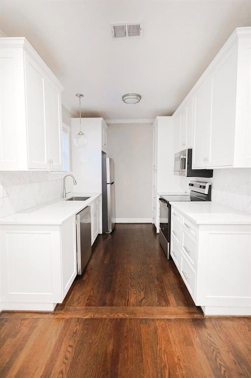 4114 Junius Street, Unit B Dallas, TX 75246 - Photo 7 of 13 a kitchen with granite countertop white cabinets and white appliances