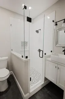 a bathroom with a shower sink and toilet