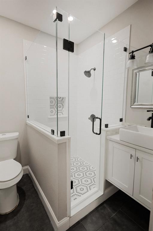 4114 Junius Street, Unit B Dallas, TX 75246 - Photo 9 of 13 a bathroom with a shower sink and toilet