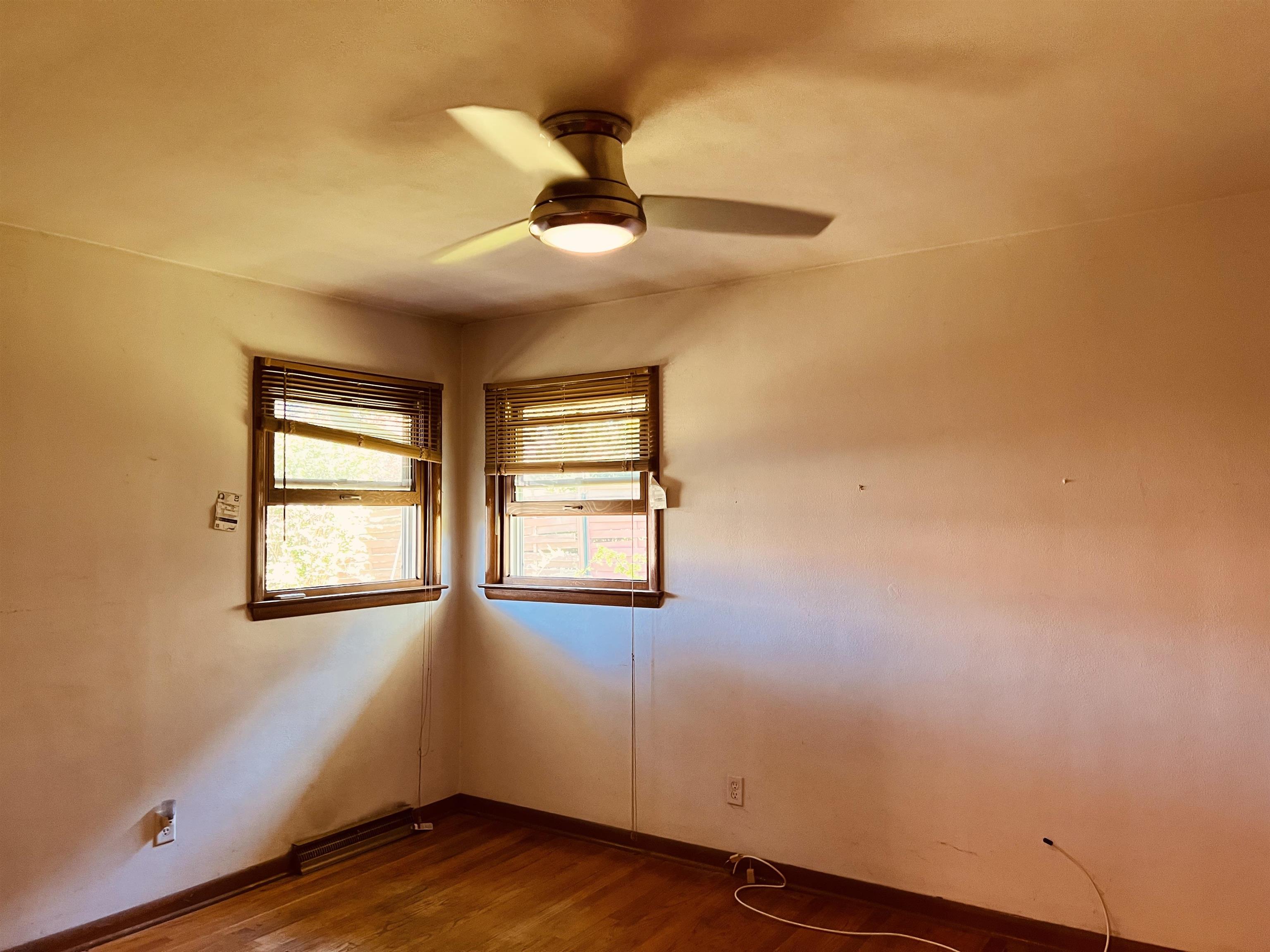1216 Hillcrest Road Rockford, IL 61108 - Photo 11 of 13 a view of an empty room with wooden floor and a window