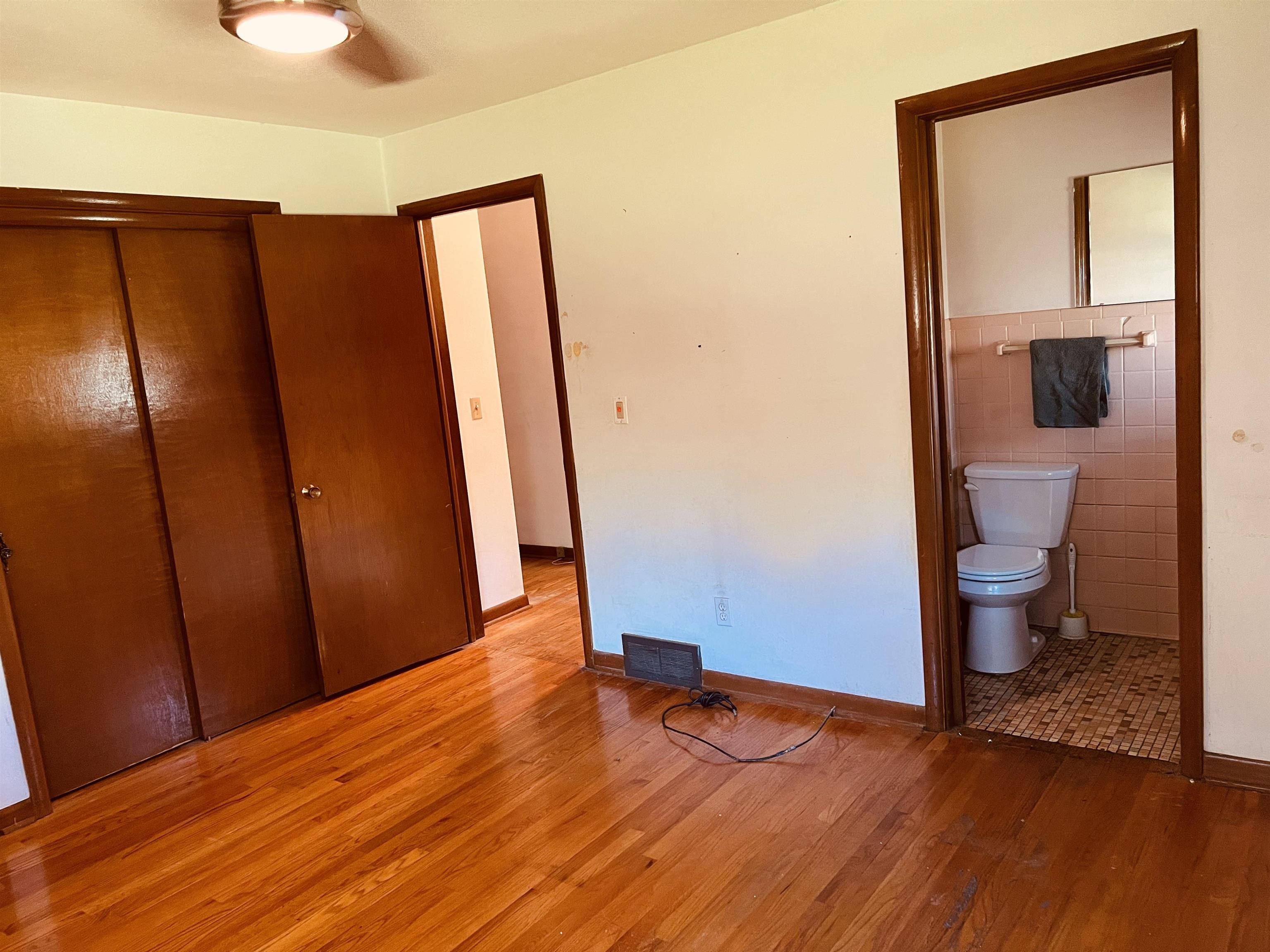 1216 Hillcrest Road Rockford, IL 61108 - Photo 10 of 13 a view of a room with wooden floor and bathroom view