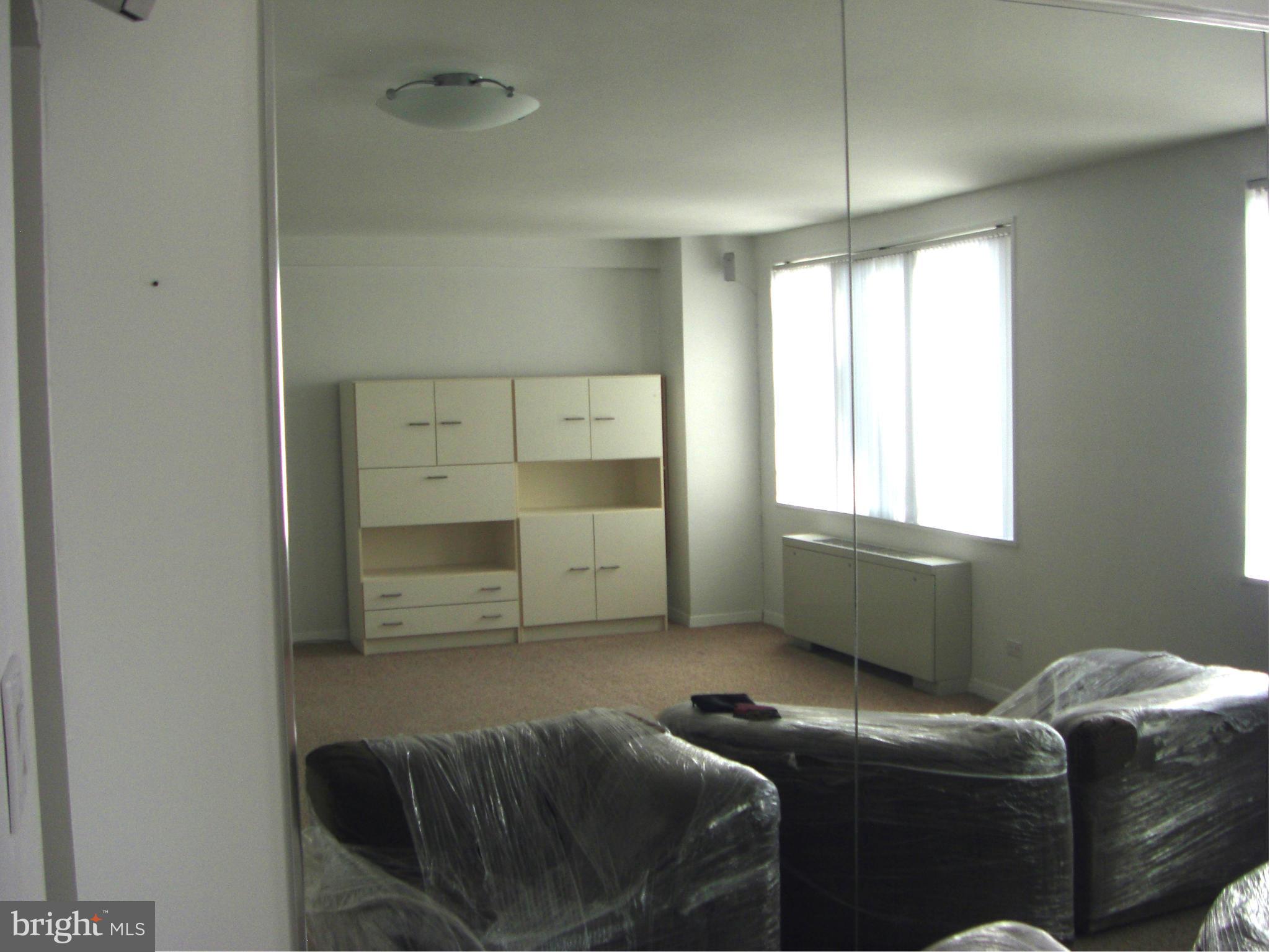 1200 North Nash Street, Unit 262 Arlington, VA 22209 - Photo 10 of 20 a bedroom with furniture and a window